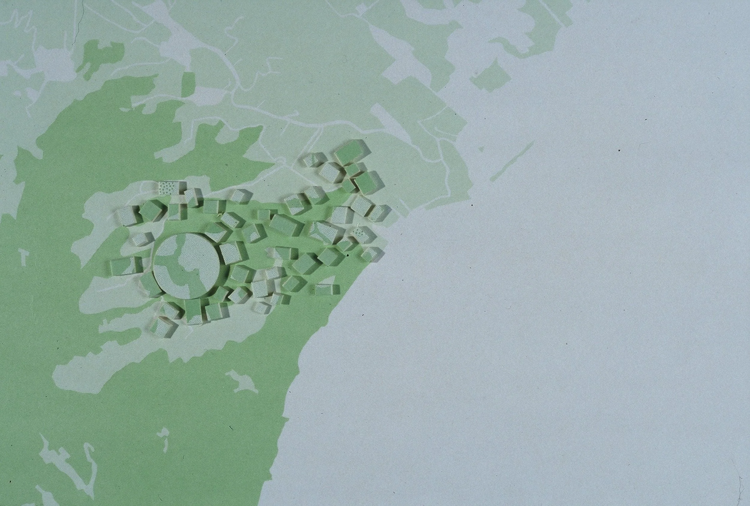 Plan urbain avec des zones vertes et un groupement de petits bâtiments en relief.
