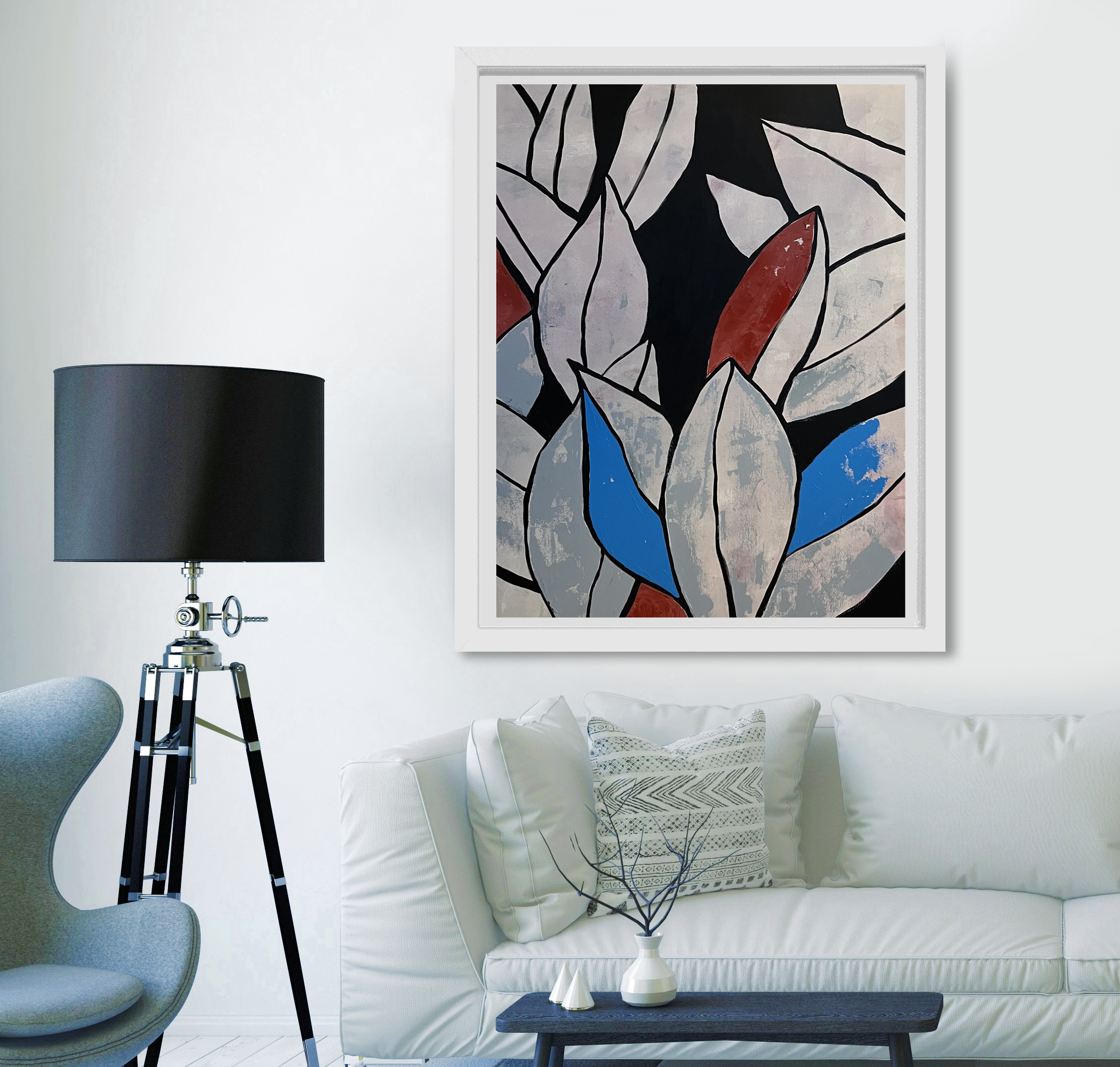 Modern living room with a white sofa, abstract artwork on the wall, black side table, and a decorative white vase with black branches. A black lampshade and a gray chair are also visible.