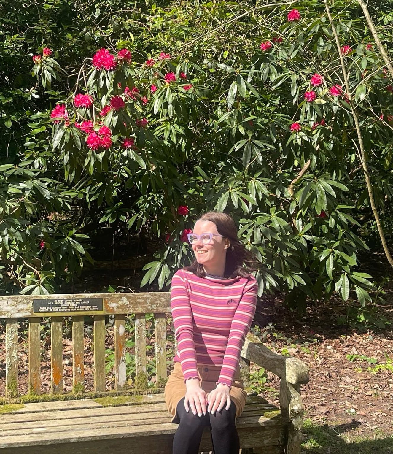 Tasha, co-founder of AuDHD and Then Some, sitting outdoors