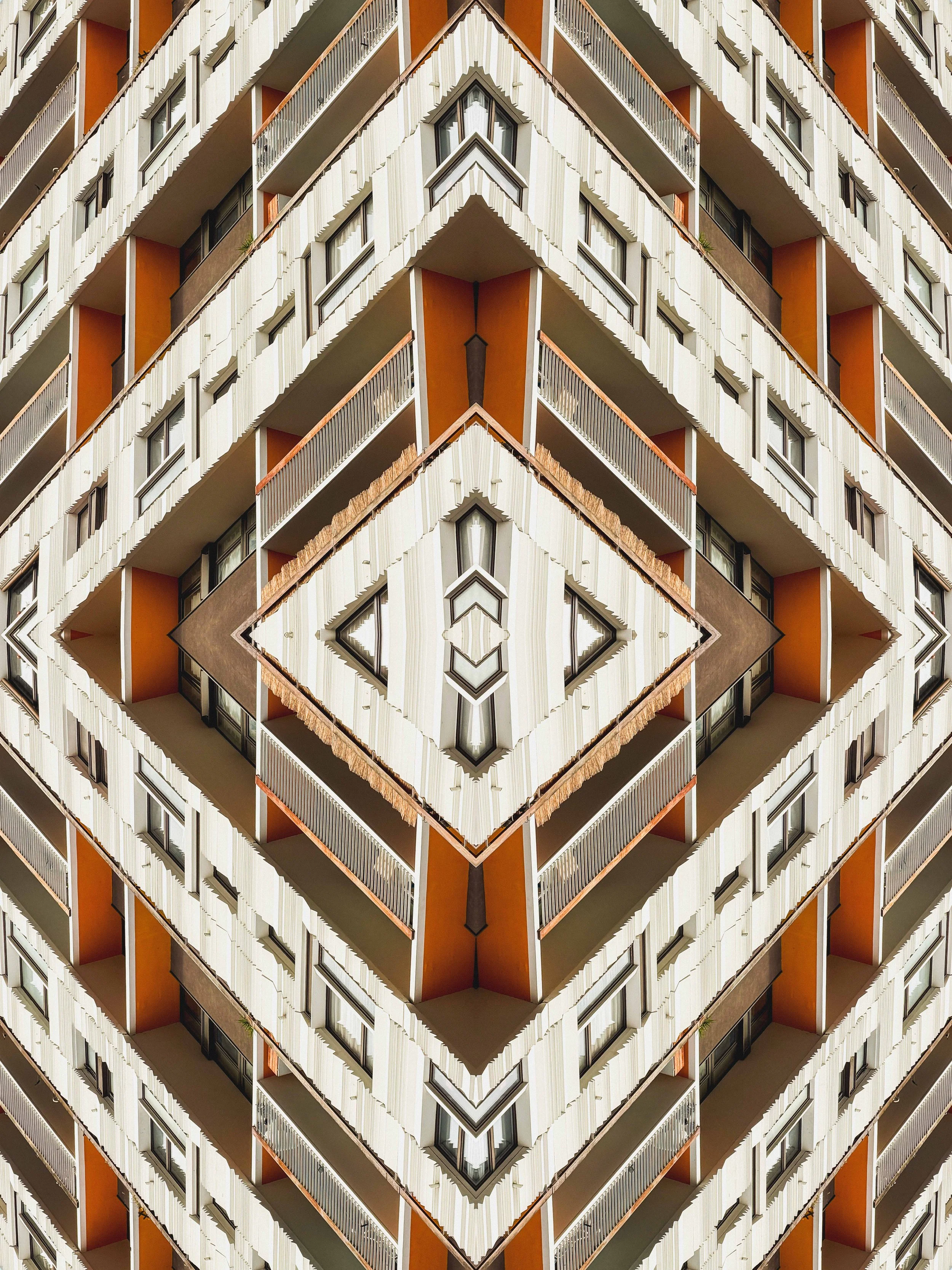 A digitally manipulated image of a building with repeating architectural patterns, creating a symmetrical, kaleidoscope effect.
