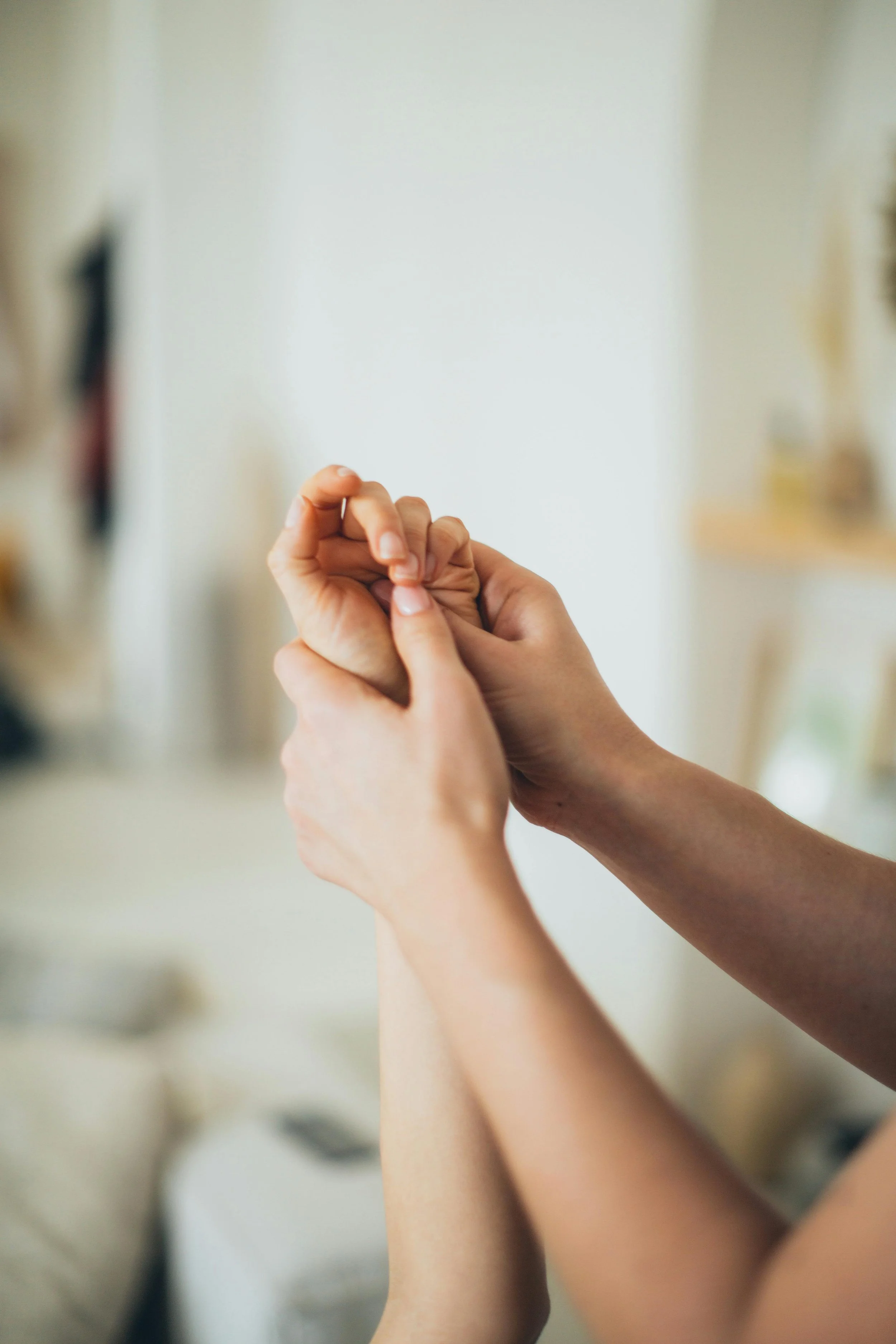 Close up of hands during kinesiology muscle testing session — holistic energy healing and complementary therapy, Luminescence Kinesiology Seddon Melbourne