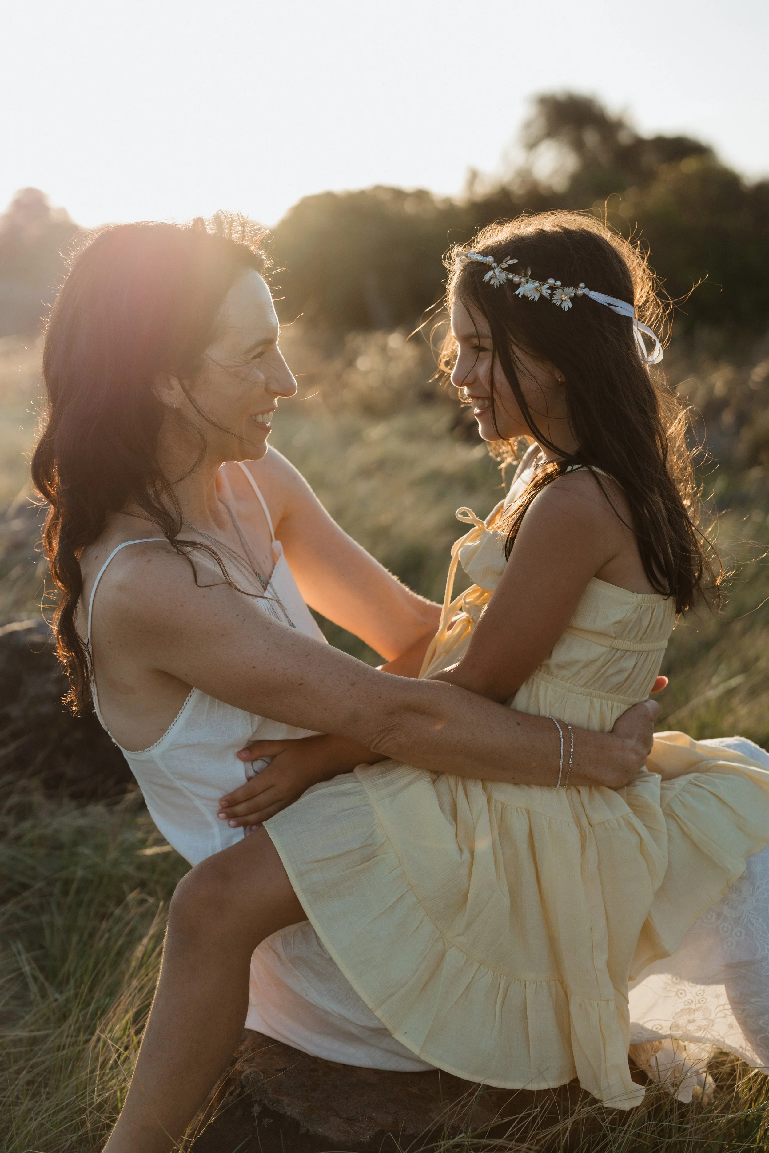 Jenna Chia kinesiology practitioner with her daughter in a sunlit outdoor setting — warm, personal and holistic approach to women's and family health, Luminescence Kinesiology Seddon Melbourne. Photo by Amy Oliver.