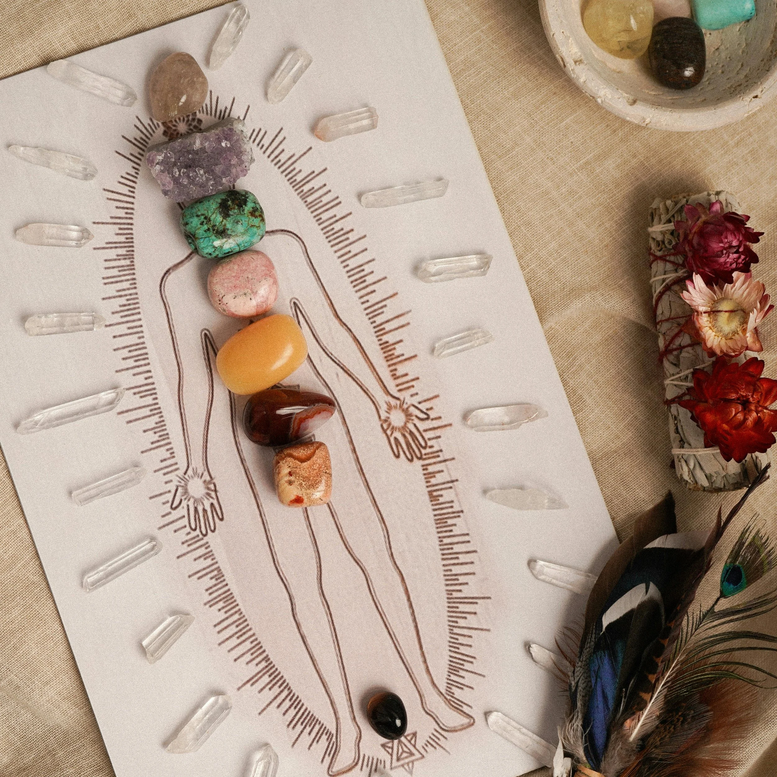 Crystals placed on chakra points with sage and flowers — representing holistic energy healing, kinesiology and complementary therapy at Luminescence Kinesiology, Seddon Melbourne.
