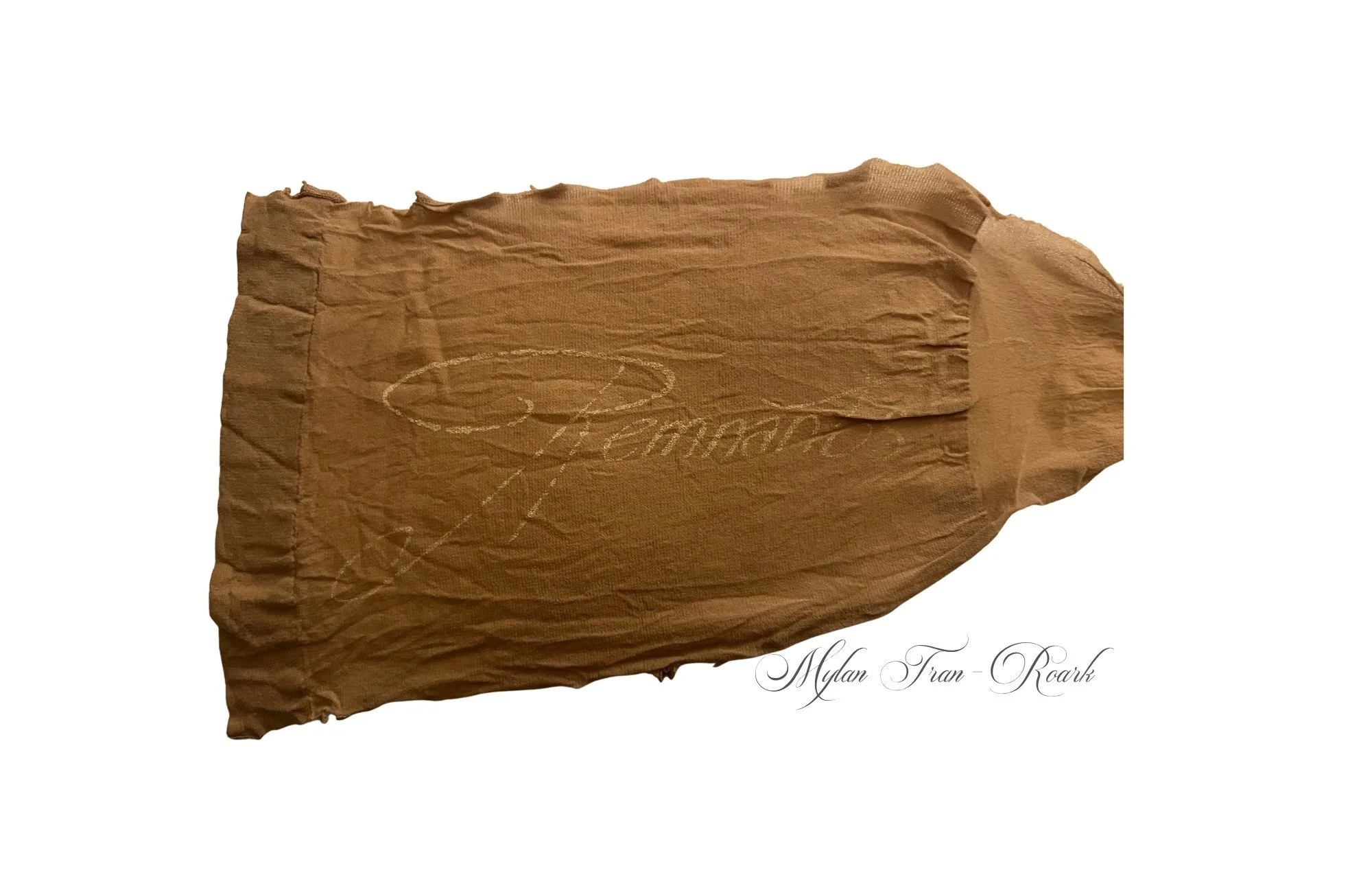 A crumpled hosiery strip with screen printed writing on it, set against a white background.