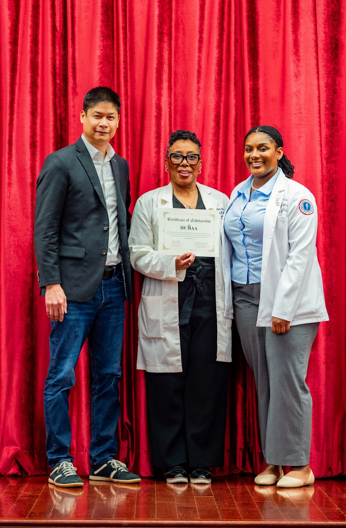 Dr. Annette Bey Shaw and Chris Chowquan presenting a HUMAA scholarship award to Jasmine McKay at Howard University.