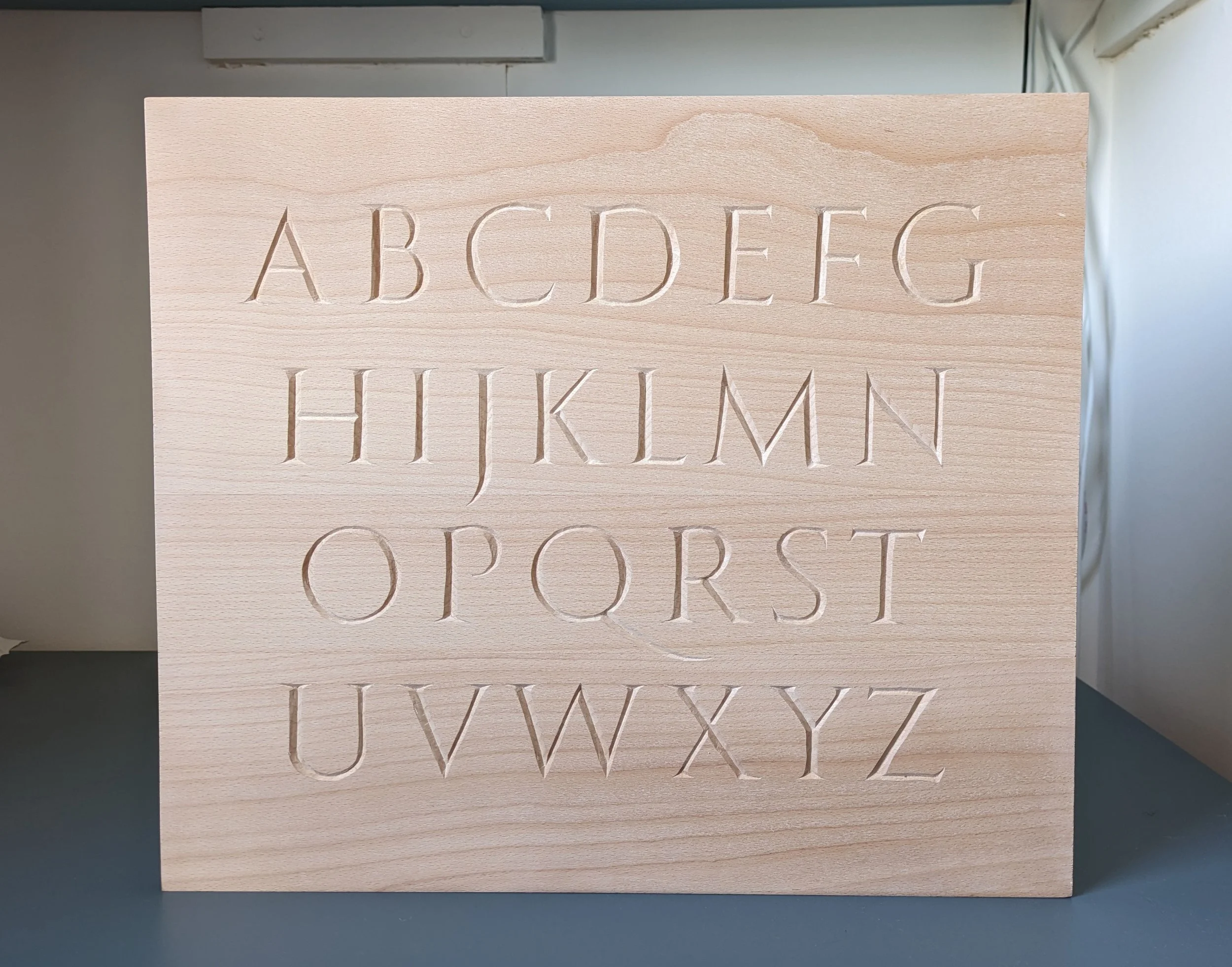 Modern alphabet based on Trajan script. Beech