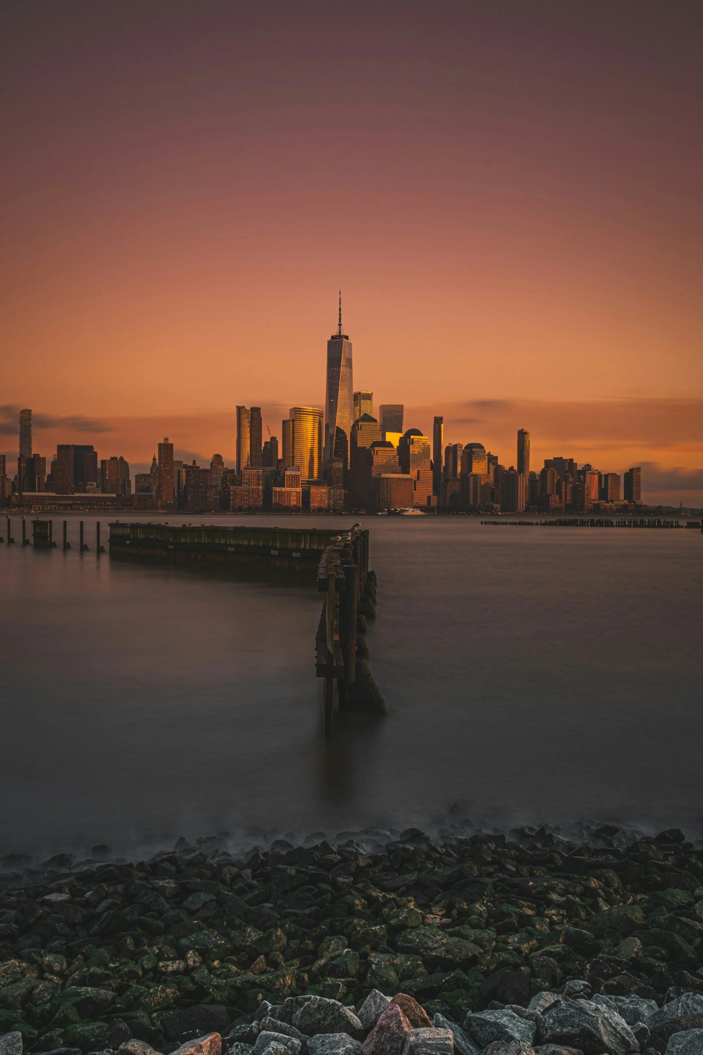 New York City skyline at sunset viewed across the water, used as a professional backdrop for Axis Engineering Consulting Services.