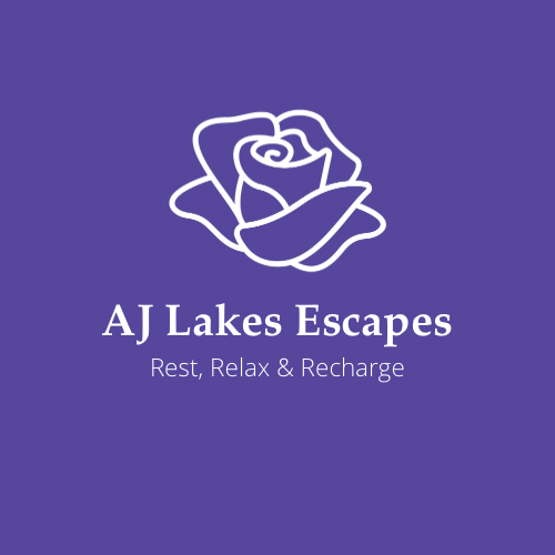 Logo of AJ Lakes Escapes with a white line drawing of a rose on a purple background, and text that says "AJ Lakes Escapes, Rest, Relax & Recharge."