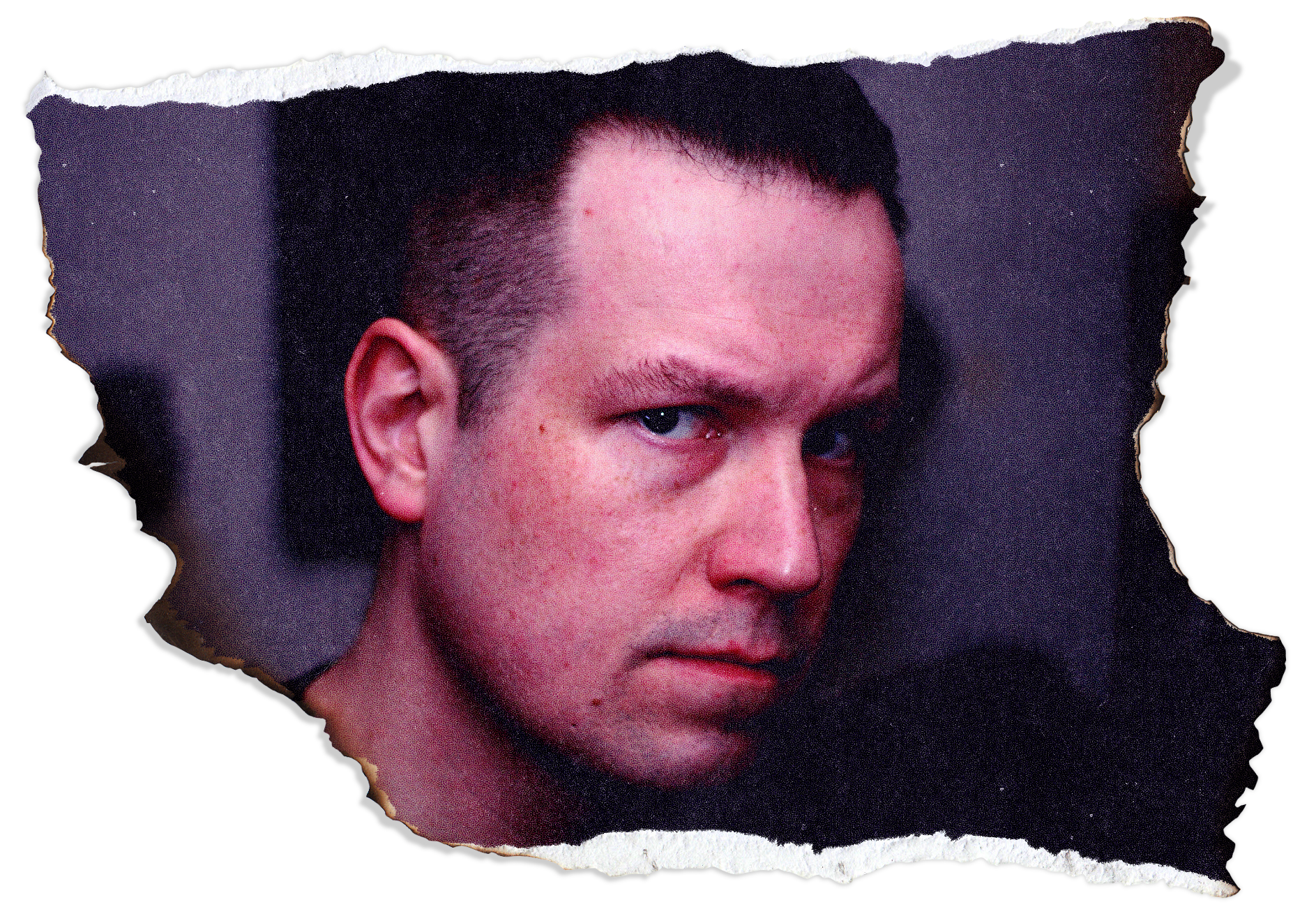 Close-up of a young man with short dark hair and blue eyes, focusing on his face and partially showing his forehead and cheek, with torn paper edges surrounding the image.