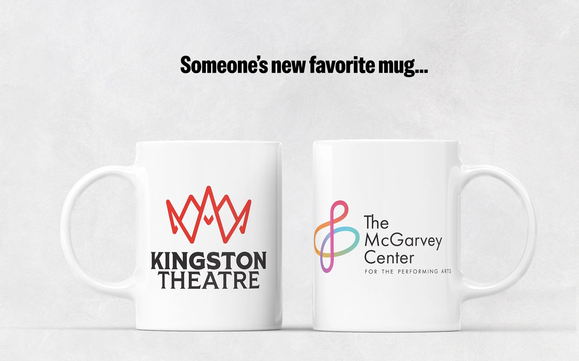 Two white mugs with logos, one for Kingston Theatre and the other for The McGarvey Center, placed on a light background with text indicating they are a person's new favorite mugs.