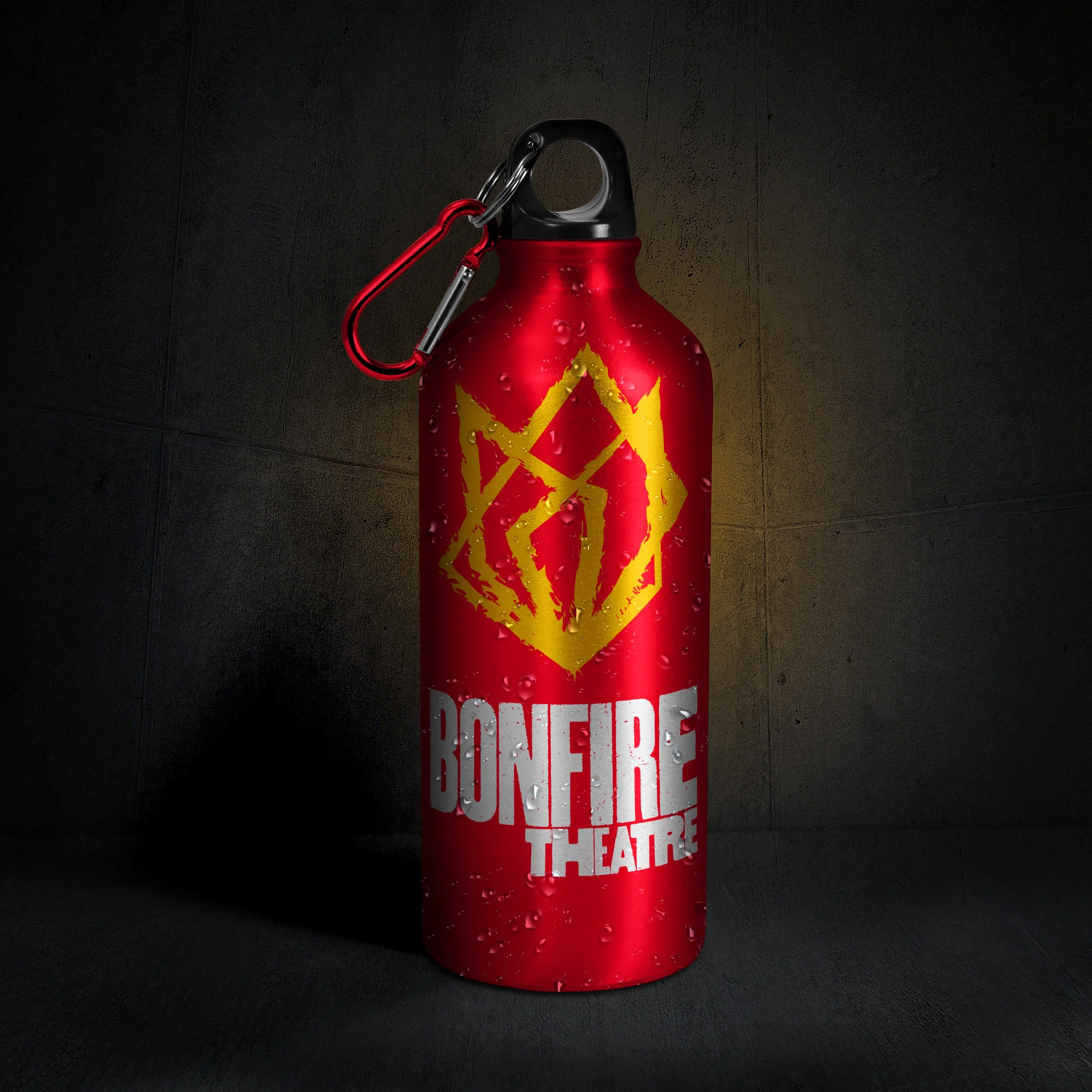 A red metal fire extinguisher with droplets of water on it, marked with a yellow star-shaped hazard symbol and warning text. It is equipped with a black handle and a red safety pin, placed against a dark background.