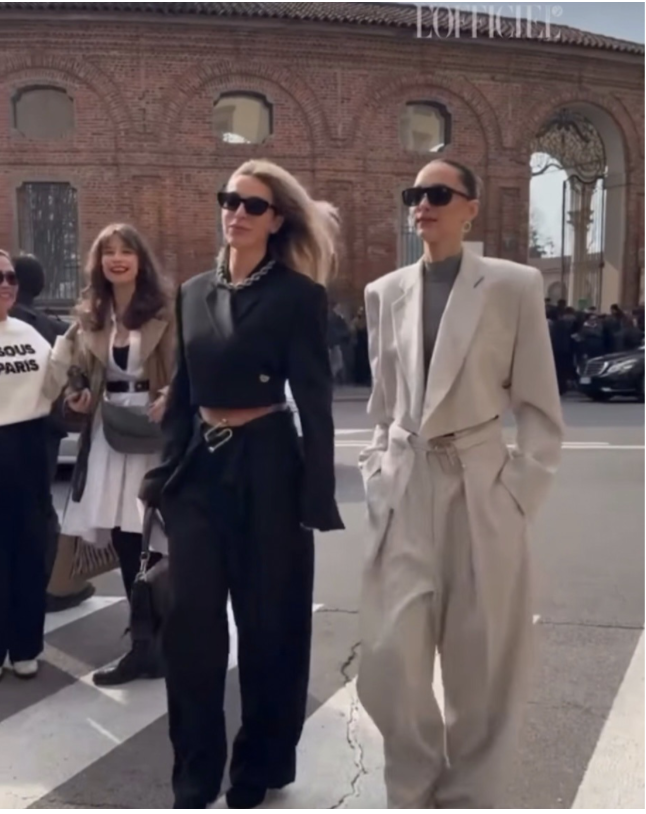Two women influencers wearing MAX MARA sunglasses walking on MILAN city street shot by street style photographer for L'Officiel and Getty Image 