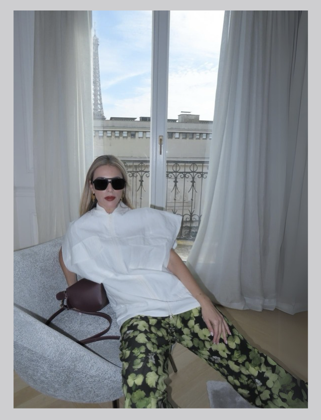 Flavia Millen sitting in white chair in Paris