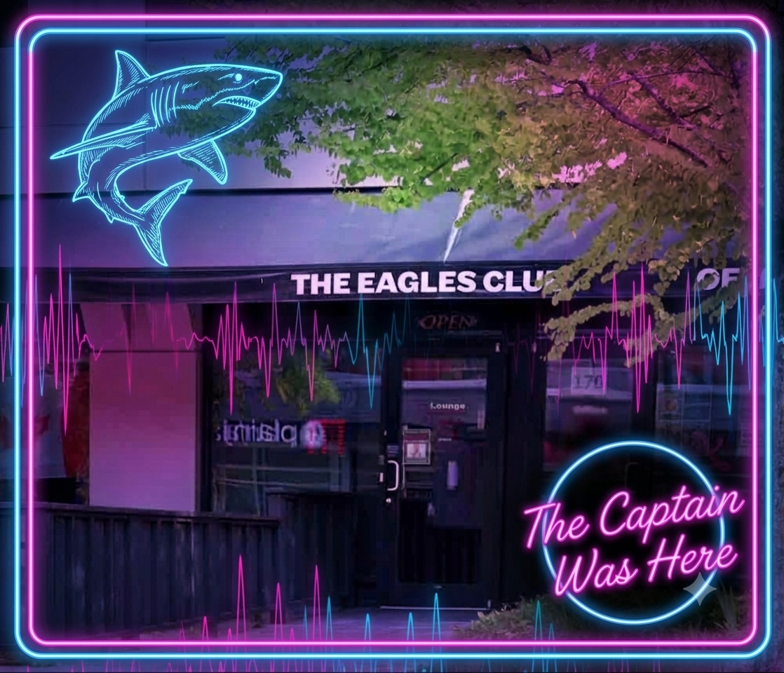 Neon sign for The Eagles Club in North Vancouver, featuring a shark and sound wave graphics, with the phrase "The Captain Was Here" in pink neon, set against the club's front entrance and greenery.