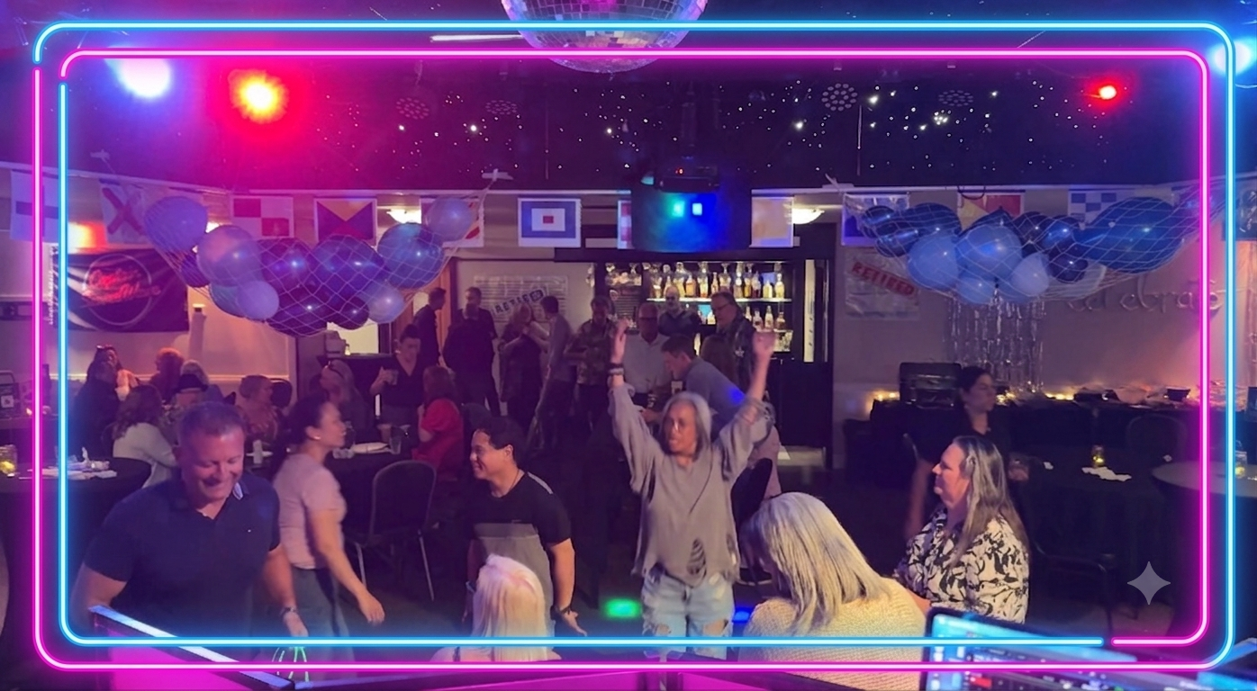 People dancing and socializing in a decorated party venue at Eagles Club in North Vancouver with neon lights, balloons, and a bar in the background.