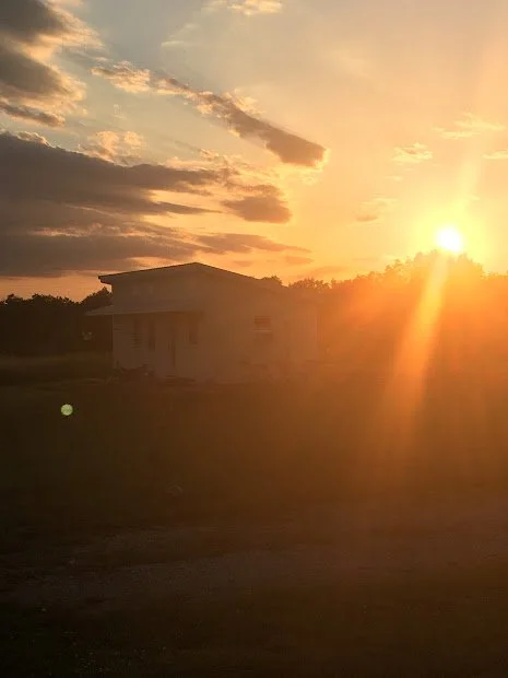 Image of a small cabin at sunset