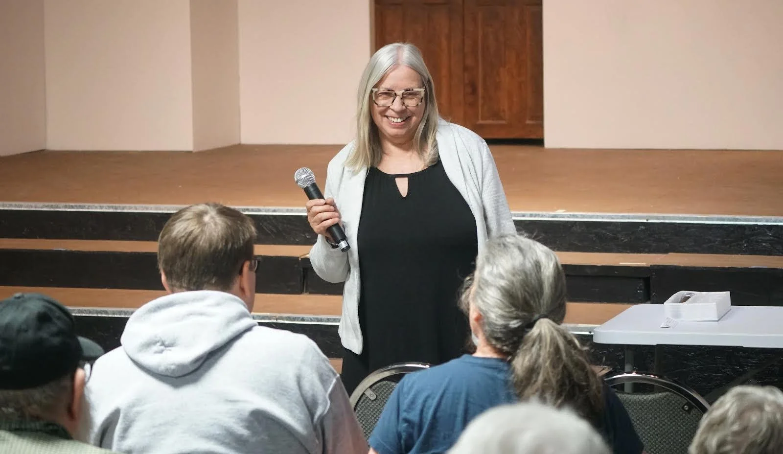 Judy McNeece, candidate for Missouri Senate District 12, talking with community members.