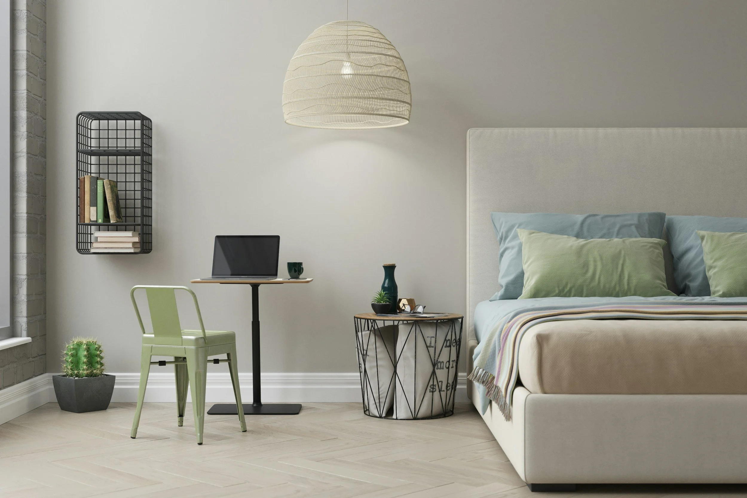 A bedroom and workspace with a bed, pillows, a side table, a desk with a laptop, a chair, a hanging lamp, a black wire bookshelf, a cactus plant, and decorative vases.