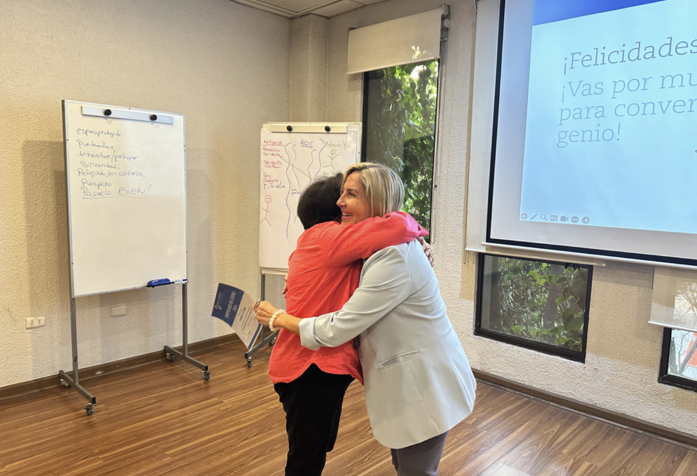Paz Nilo rceiving a hug from a grateful student at the end of the change your mind ... create new results class