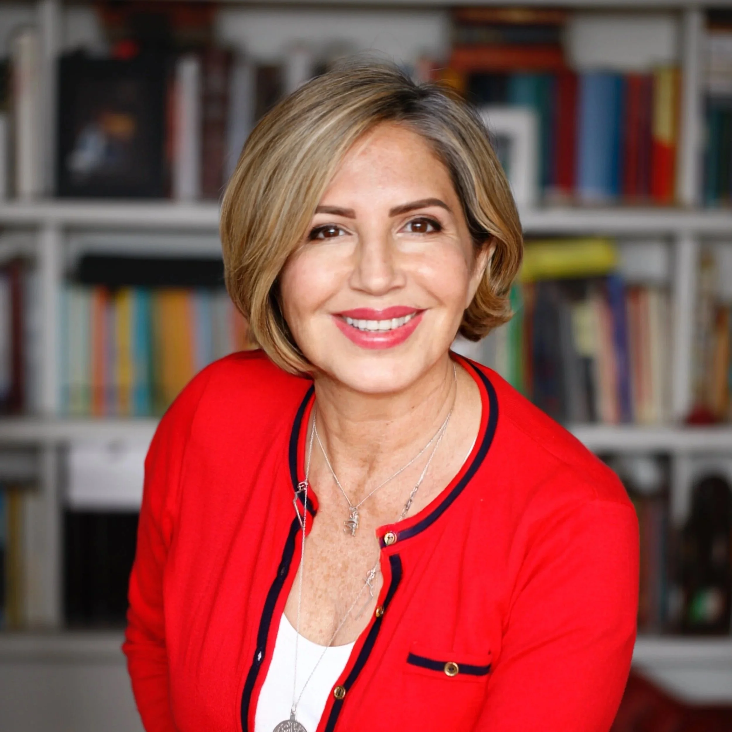 Paz Nilo founder of Paz of Mind smiling  in a library.