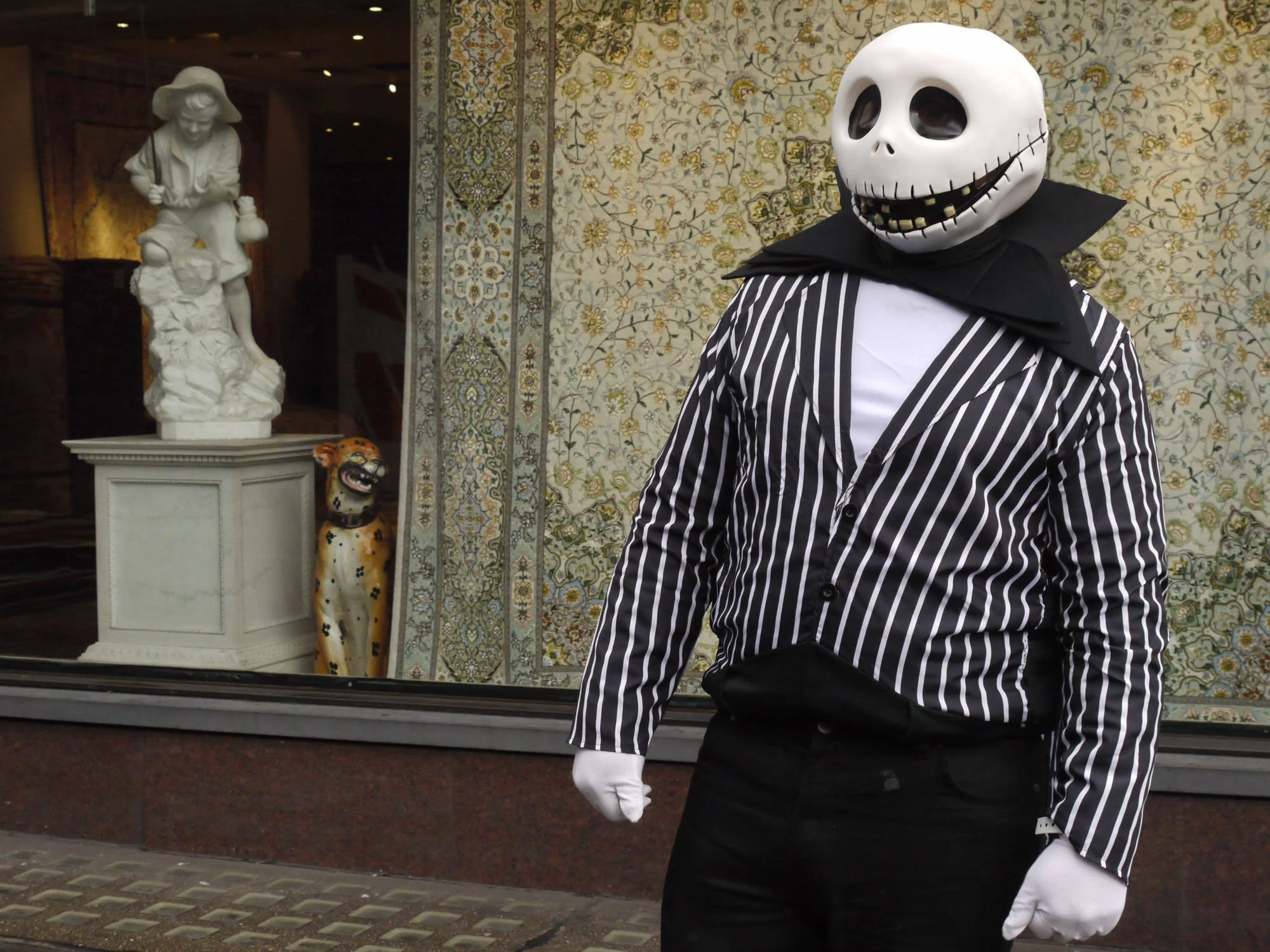 Bob Watkins P1130889 New year parade Piccadilly London 1st January 2017 Ghoolish figure  and statue in shop window .jpg
