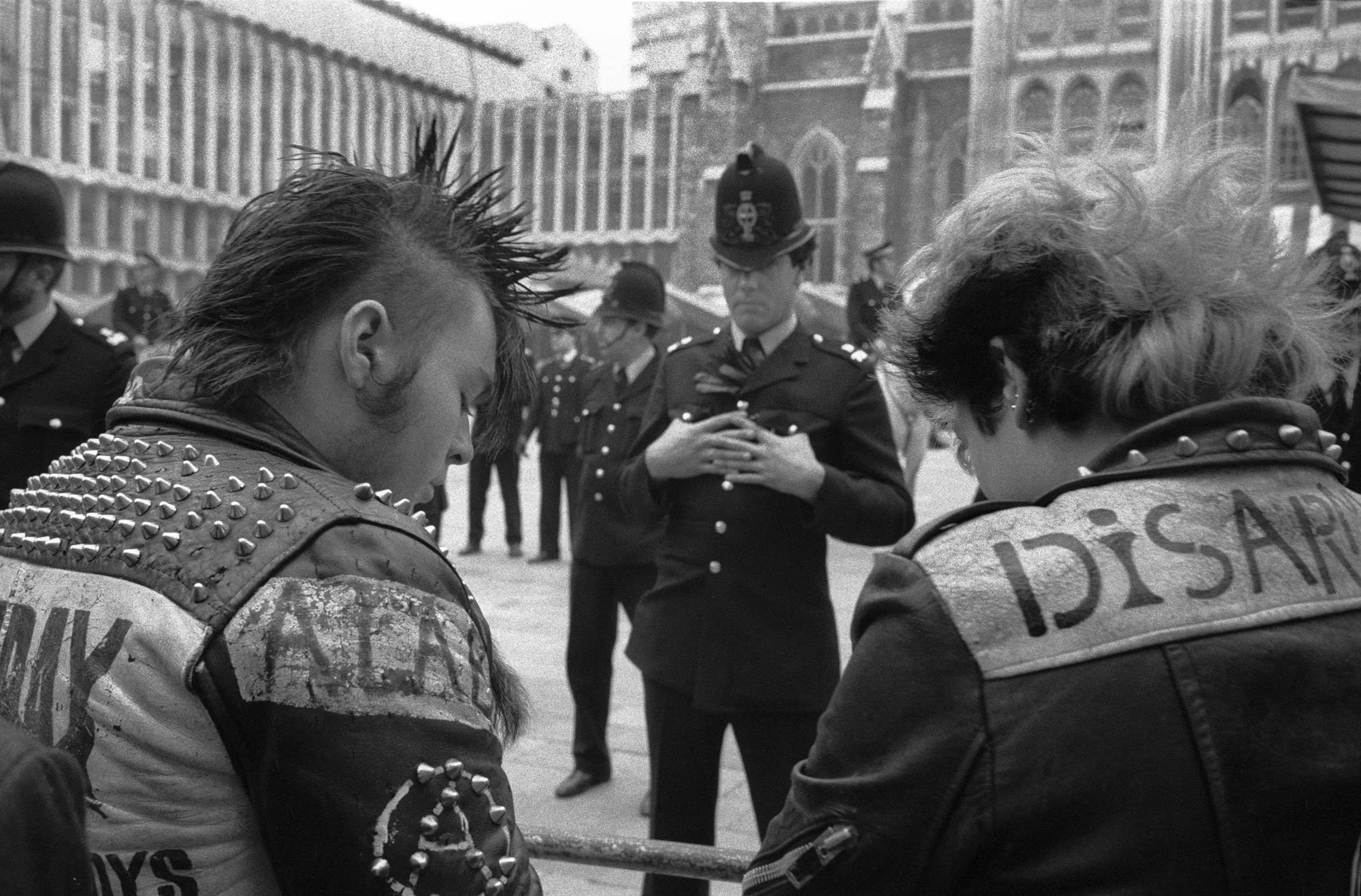 Bob Watkins  punks with policeman Campaign for Nuclear Disarmament  Demonstration at the Guidhall City of London  Sept83 neg39 5 6  .jpg