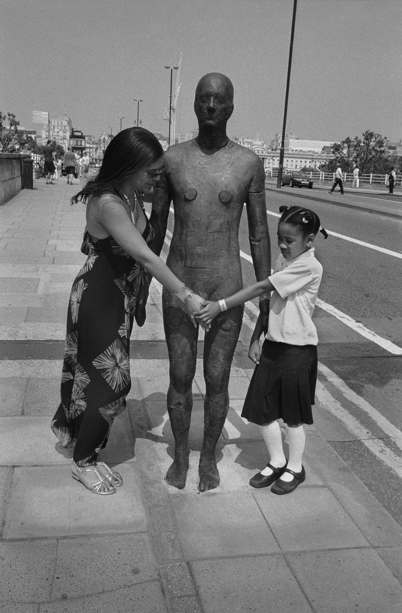 Bob Watkins  Anthony Gormley statue with mother and daughter on Waterloo Bridge London March 2008 .jpg