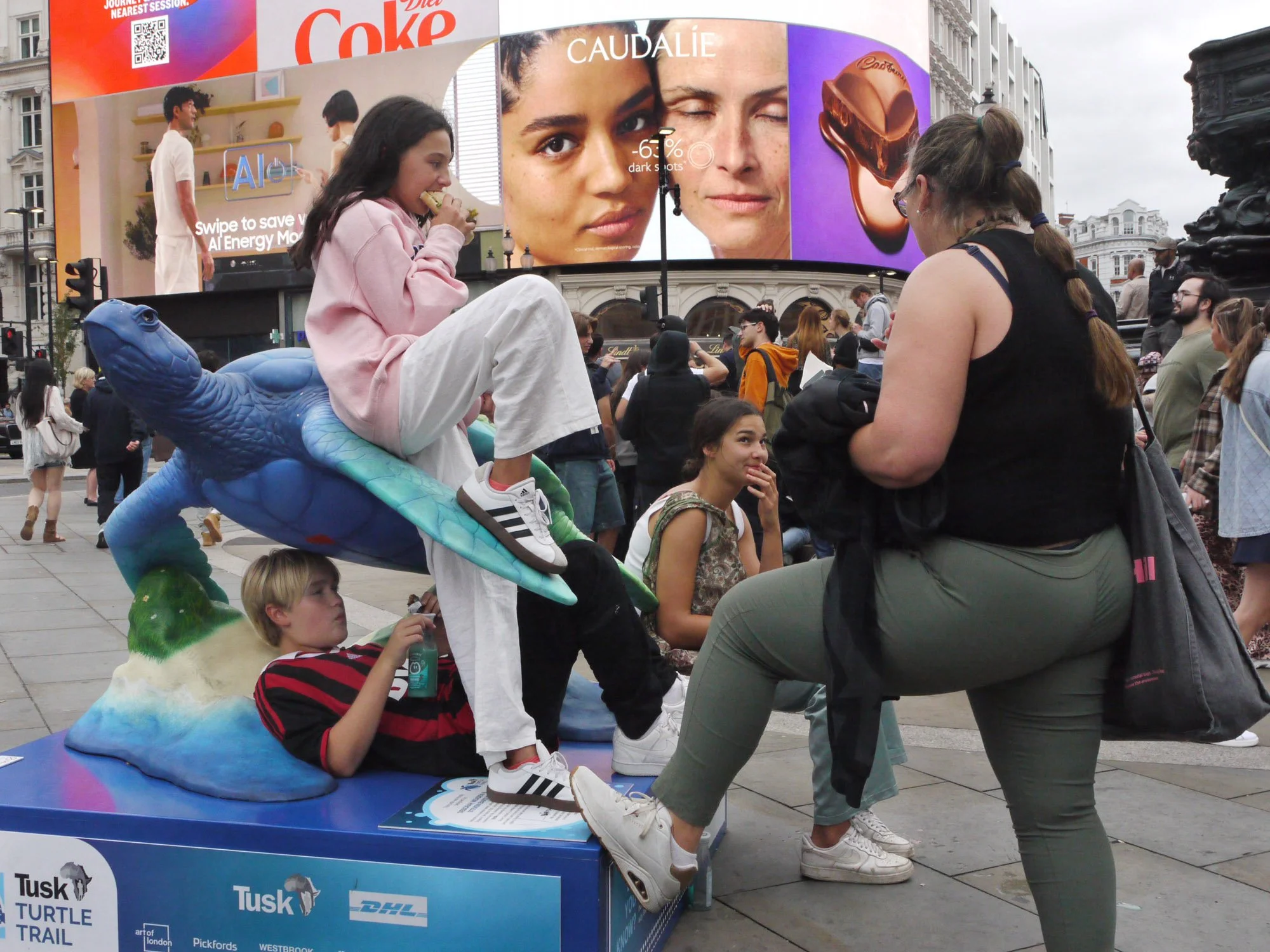 Bob Watkins  P1040316   August 2025   Piccadilly Circus turtle with tourists    .jpg