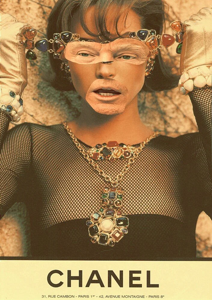 Person lying on the ground wearing a mesh top and multiple colorful jewelry pieces, including large statement necklaces and rings, holding a pair of sunglasses with multicolored stones, in front of a Chanel advertisement with Paris addresses.