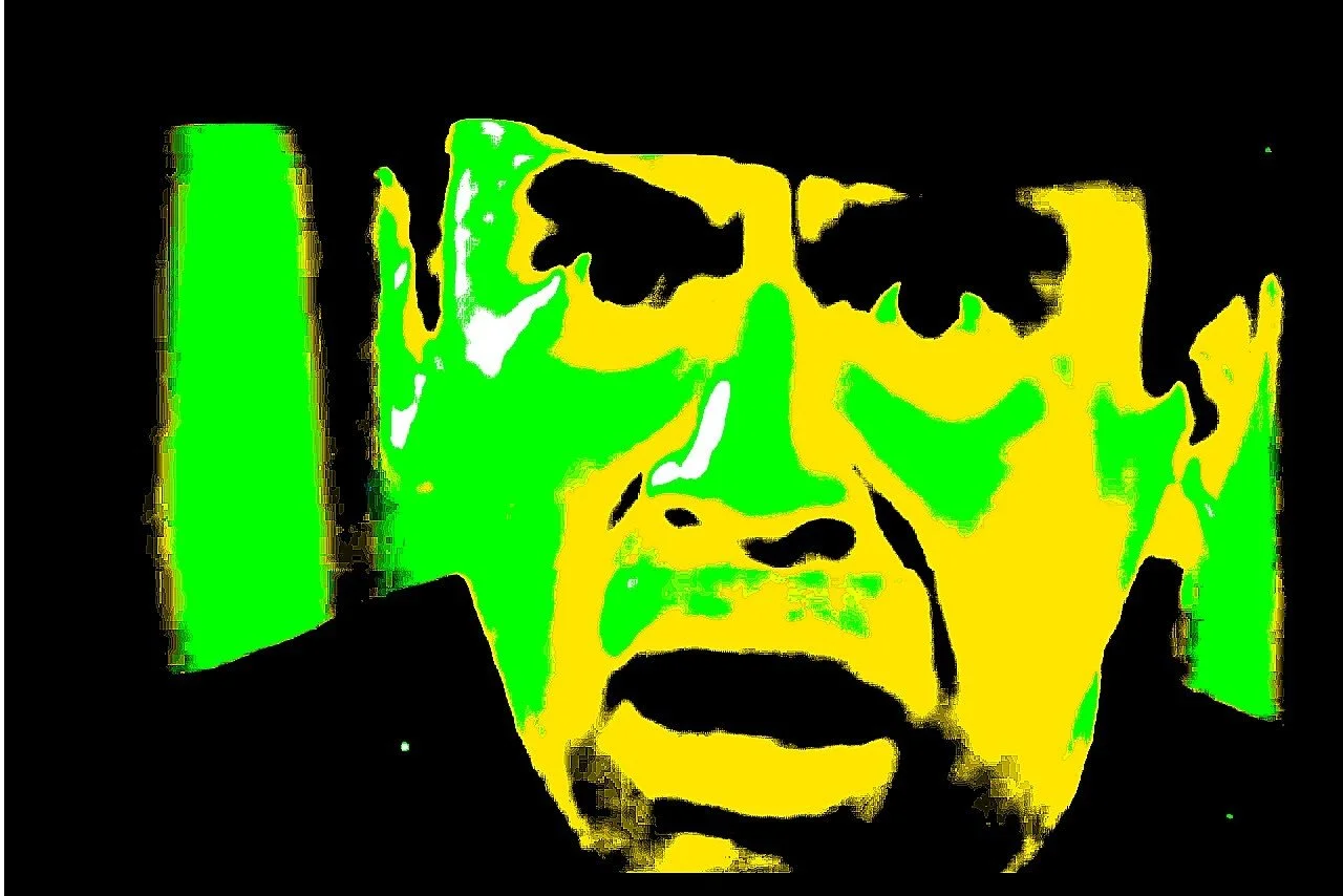 Stylized digital image of a person's face with glasses, with prominent black, yellow, green, and white colors.