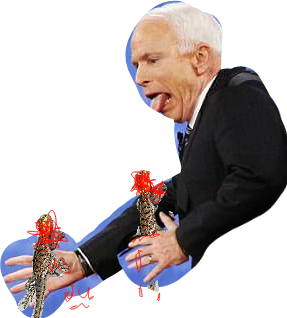 An elderly man in a tuxedo with white hair sticking out his tongue and holding two small, furry, decorated animal figurines, possibly cats.