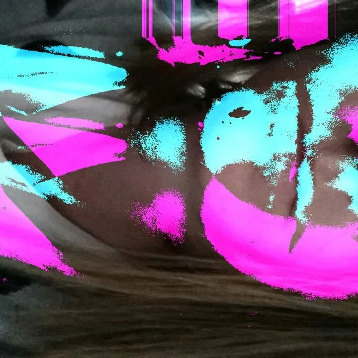 Abstract graffiti art with neon pink, blue, and black paint splatters and streaks.