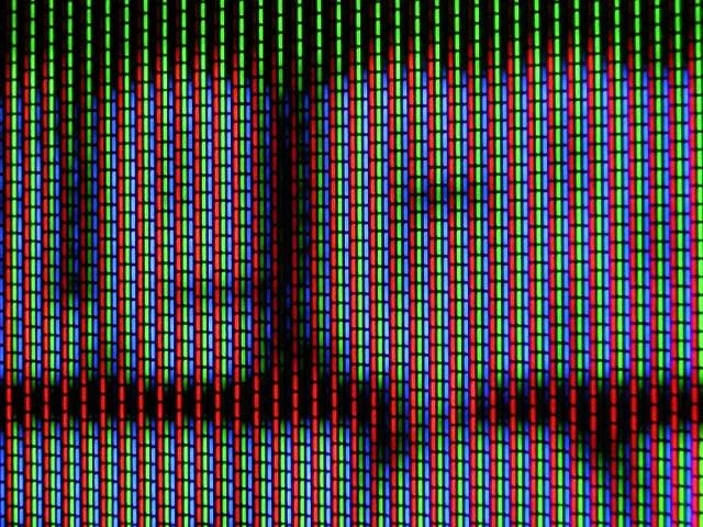 Close-up of a computer screen displaying red, green, and blue vertical lines of pixels.