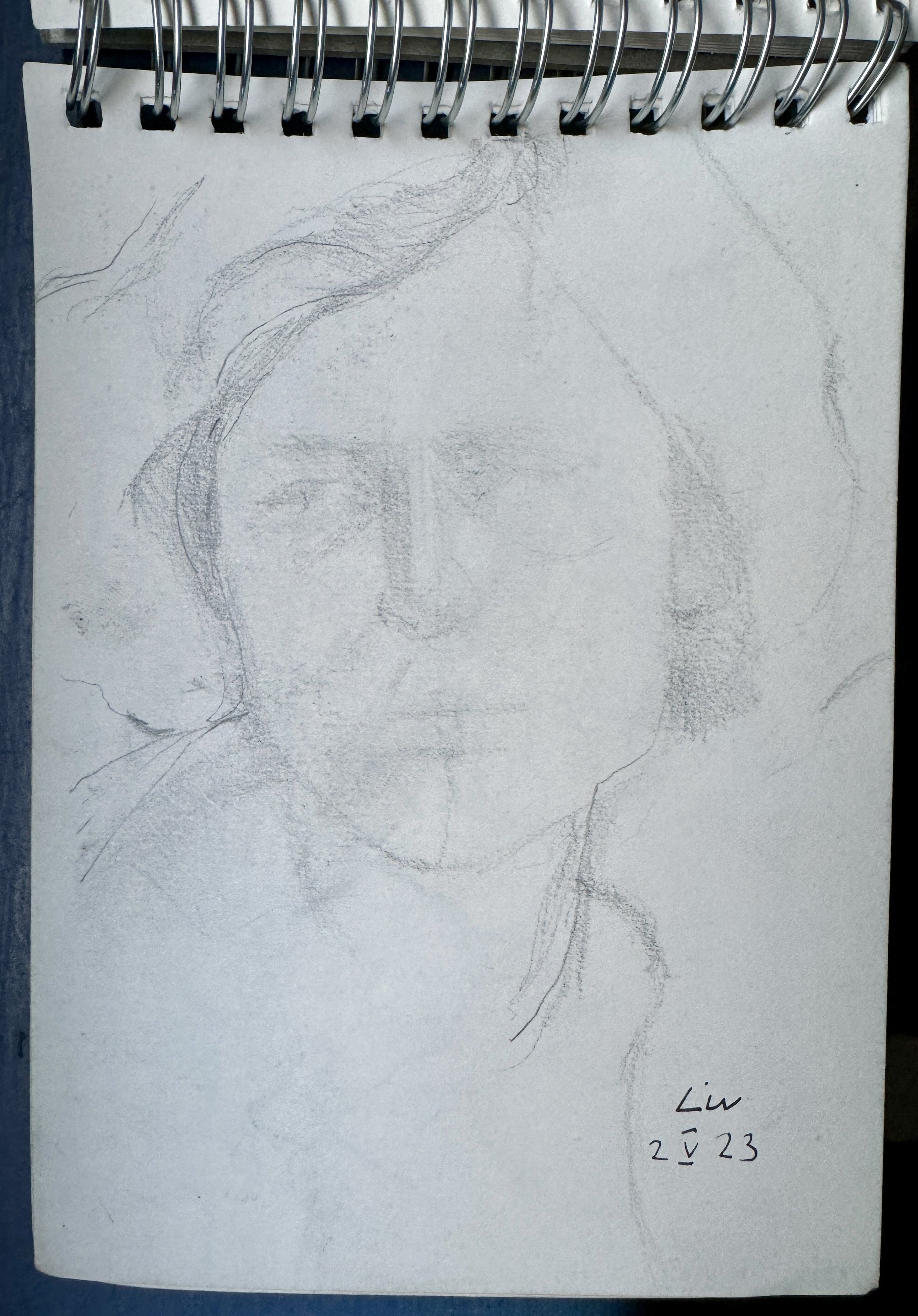 A sketch of a person, signed by Liu, dated 23/2/23, on a spiral-bound notebook page.