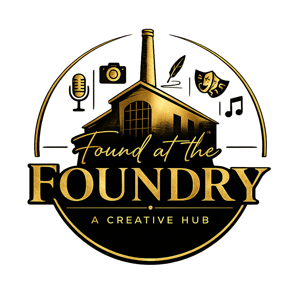 Logo for 'Found at the Foundry,' a creative hub, featuring an illustration of a factory building with miscellaneous creative symbols around it, including a microphone, camera, feather, comedy and drama masks, music note, and paintbrush, all in gold on a black background.
