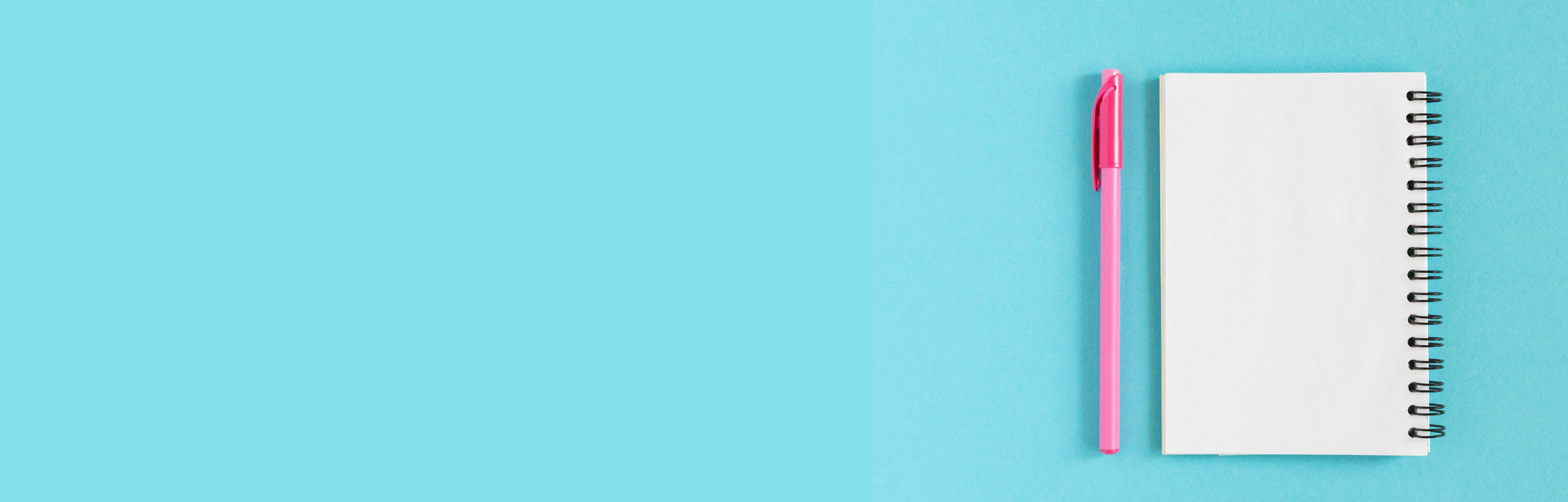 notebook and pen on blue background