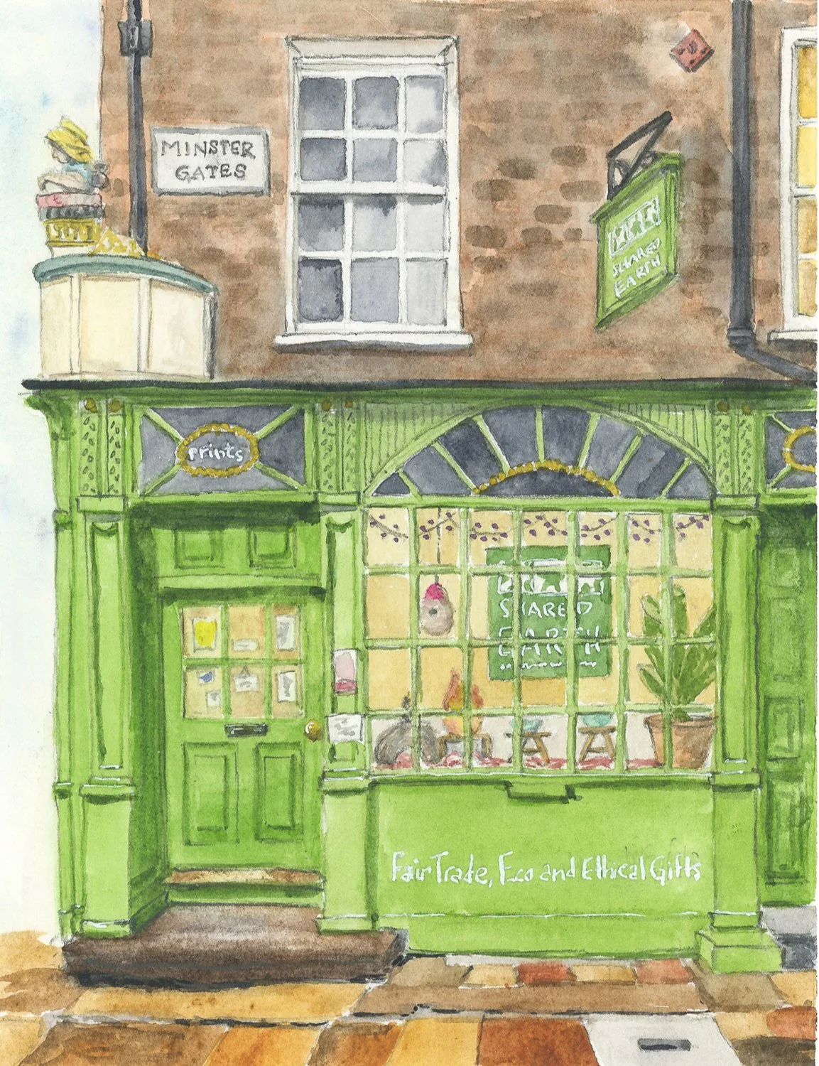Watercolor painting of a storefront with a bright green façade and door. The store has a sign that reads "FairTrade, Eco and Ethical Gifts". Inside the window, various items including plants can be seen. An arched window is above the storefront, and 
