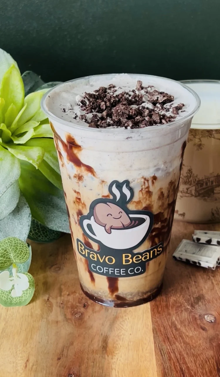 Cookies and cream iced latte in a Bravo Beans cup