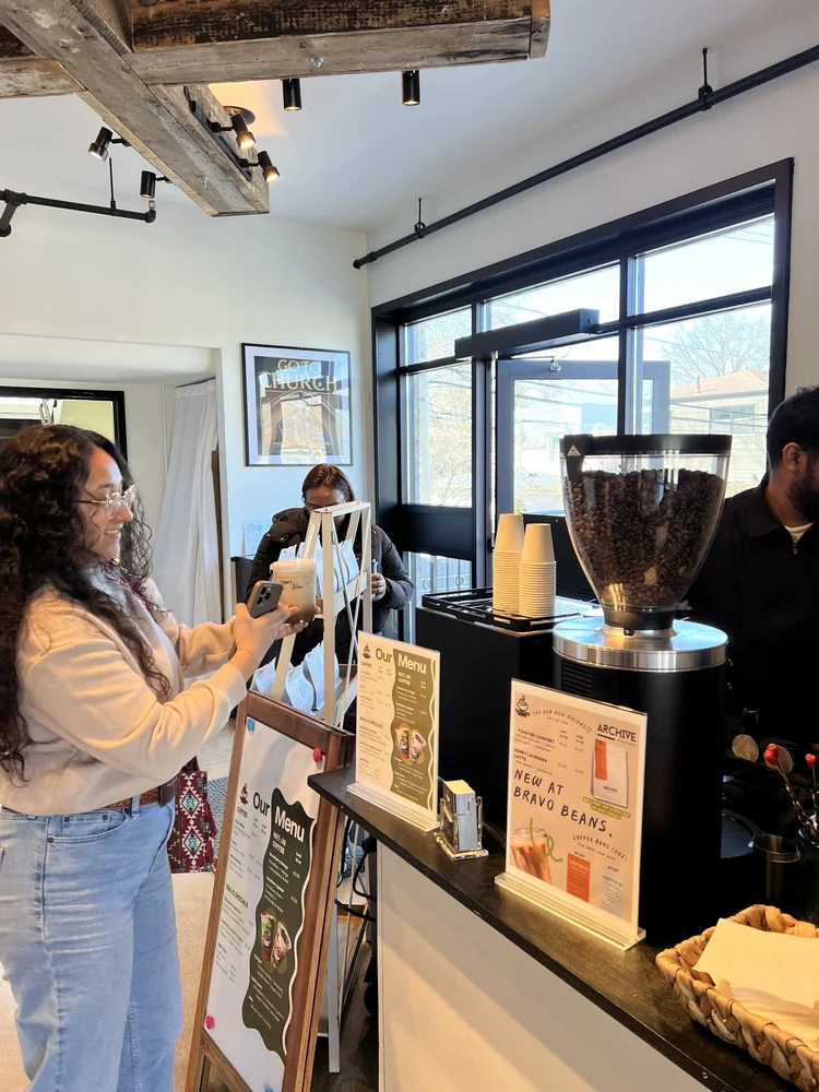 Guest picking up a drink at the Bravo Beans coffee bar