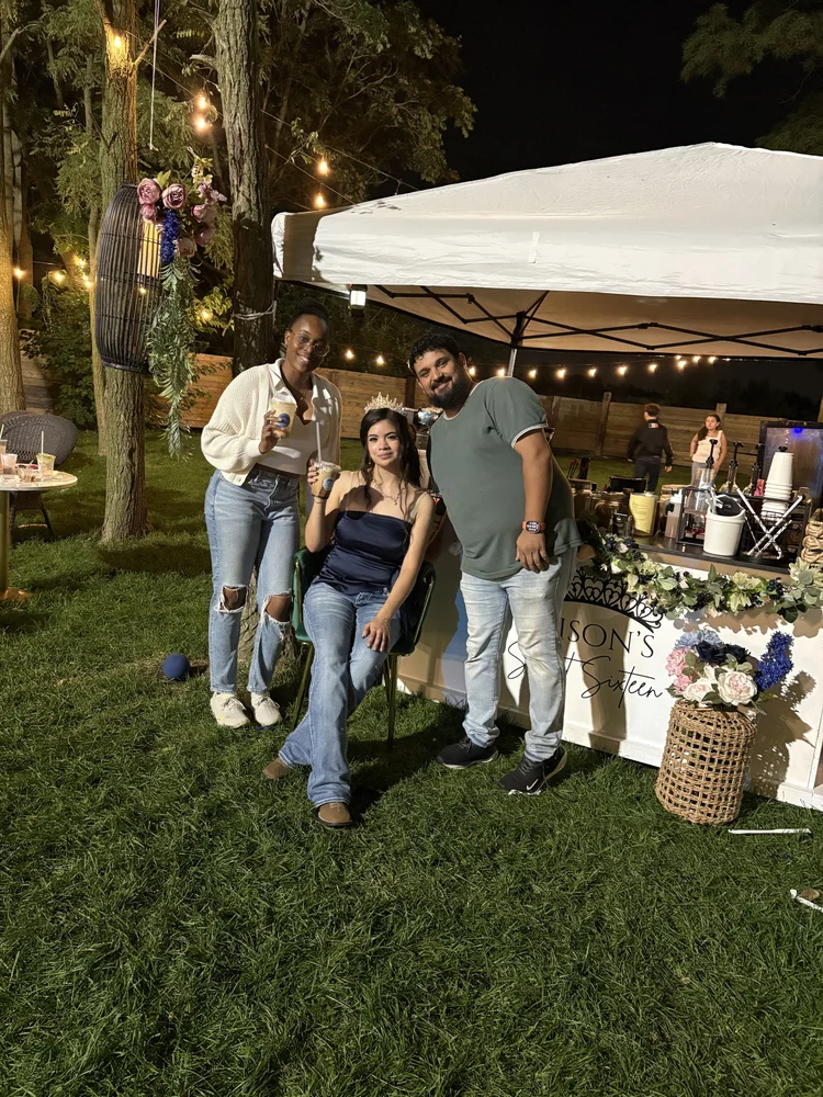 Guests at the Bravo Beans cart during an evening outdoor event