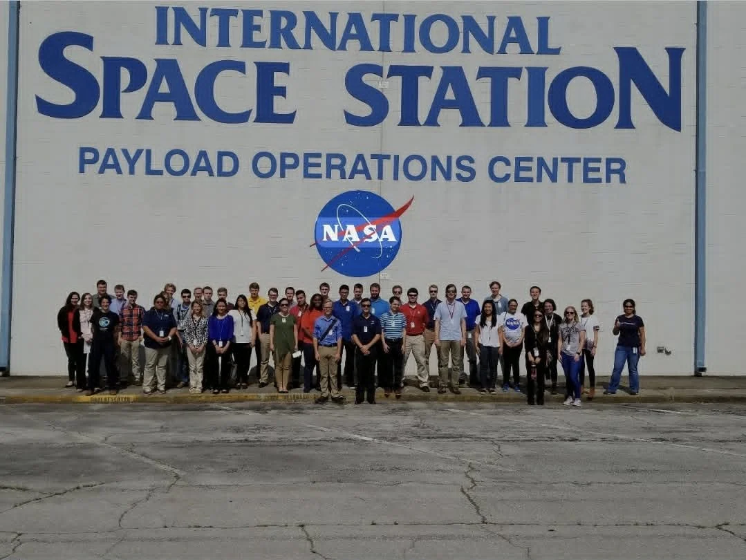 MSFC Interns standing outside the International Space Station Payload Operations Center building