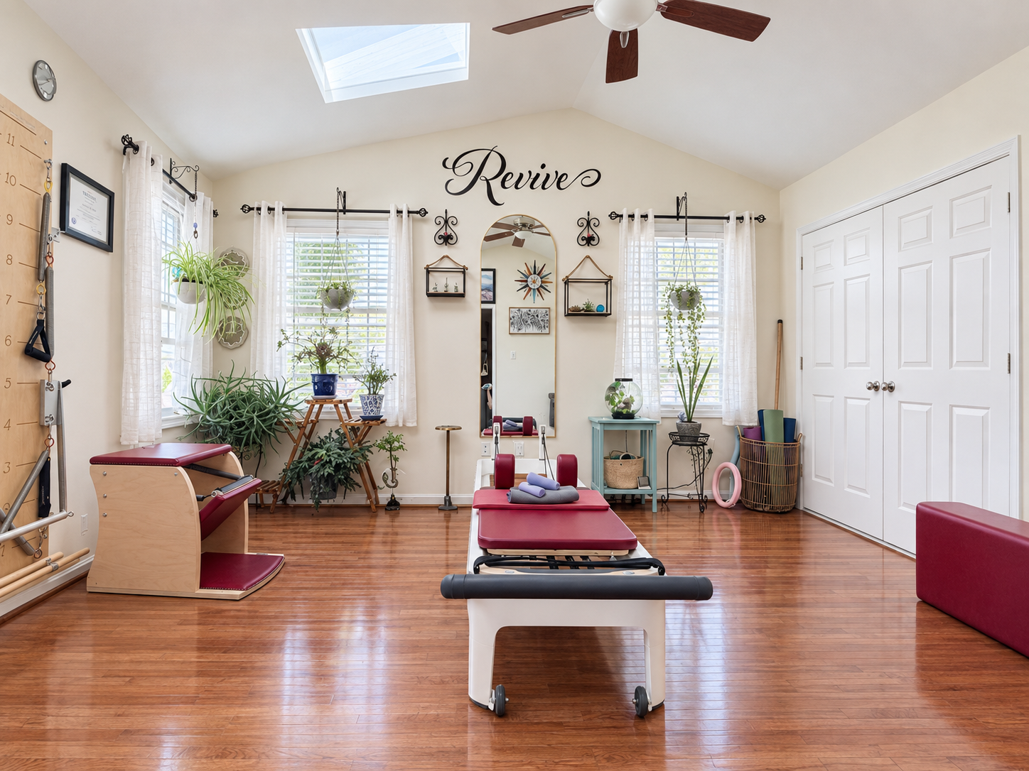 Bright and welcoming private studio space at Revive Therapeutic Pilates in Laurel, Maryland, featuring a professional reformer, a springboard, a Pilates chair and other equipment.