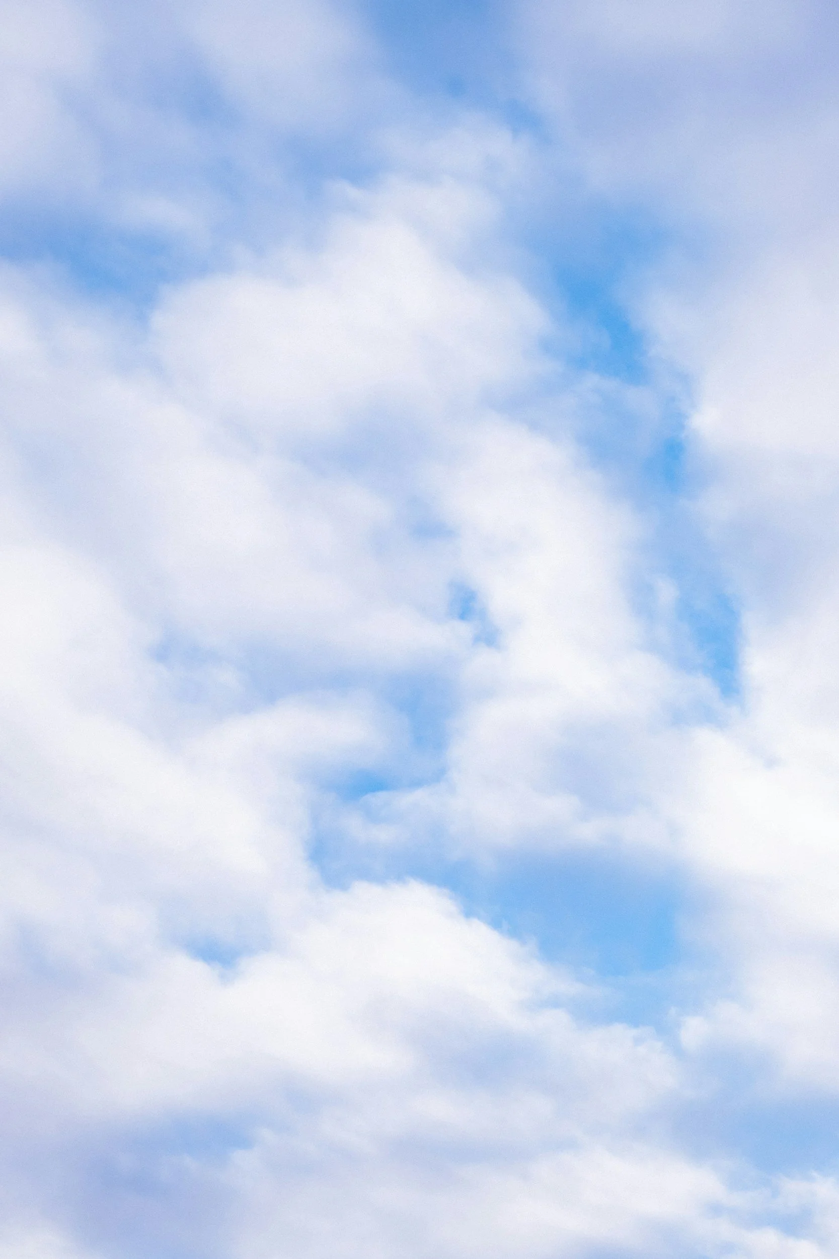 Cloudy sky with patches of blue sky and white clouds.