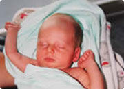 Newborn baby sleeping in a hospital bed