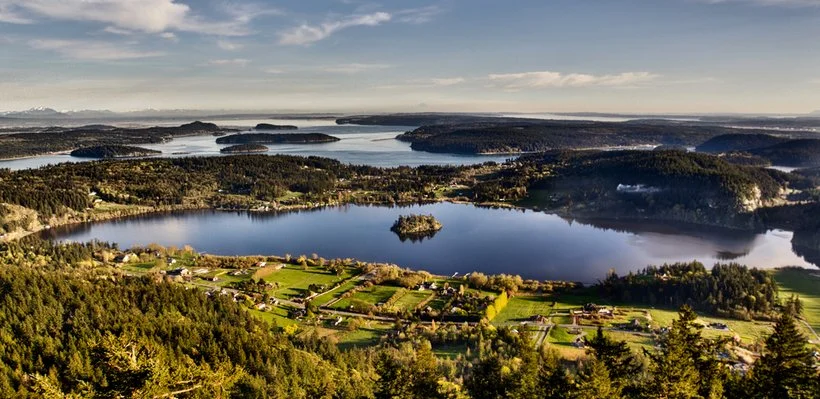 Aerial view of lakes, forests, and a rural village.