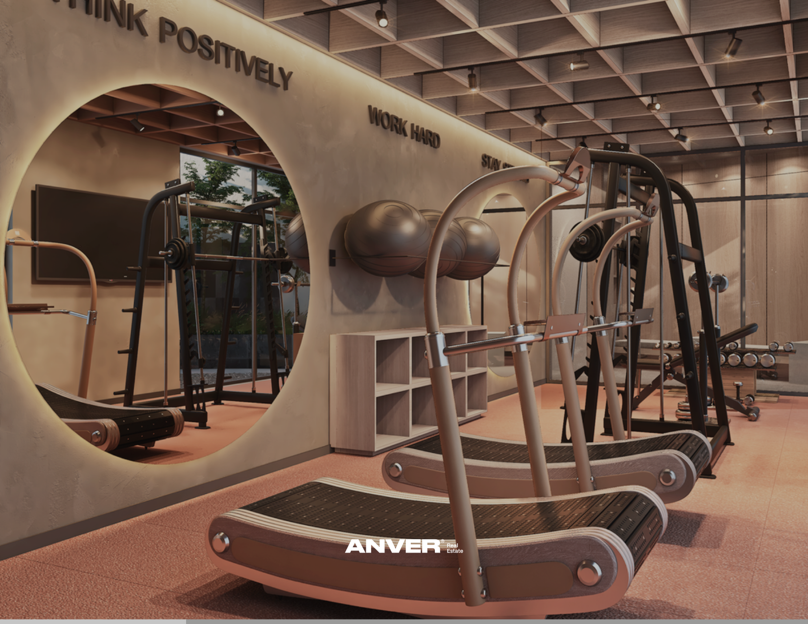 Gimnasio moderno con equipo de ejercicio, pelota de estabilidad y una pared con frases motivacionales en inglés, como 'Think Positively', 'Work Hard' y 'Stay'.