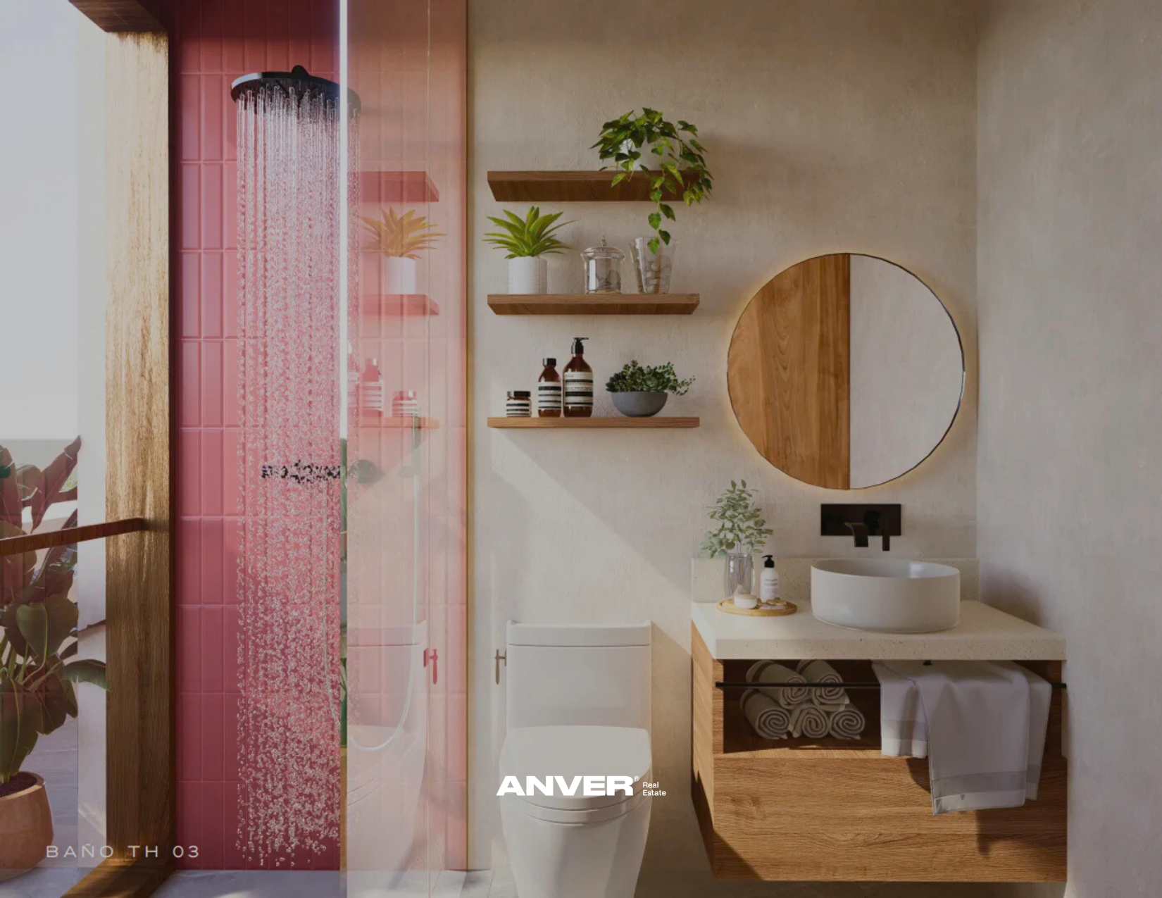 Baño moderno con pared de azulejos rosados en la ducha, lavabo de cerámica blanca sobre encimera de piedra, espejo redondo de madera, estanterías de madera con plantas y accesorios, y un inodoro blanco. Planta en maceta y accesorios en la encimera.