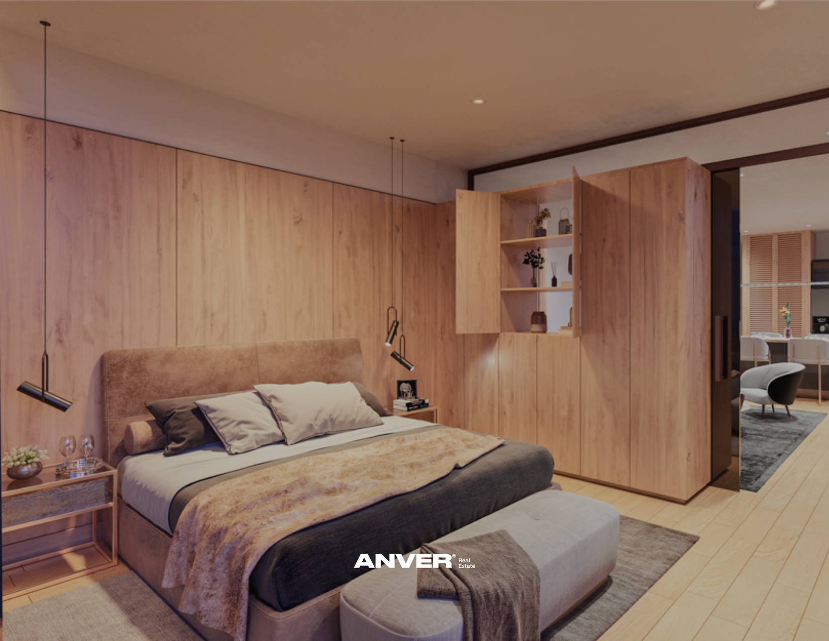 Dormitorio con paredes de madera clara, cama con colchas de tonos beige y gris, almohadas en tonos neutros, mesa de noche con libro y decoraciones, lámparas de lectura colgantes y área de descanso con sillón en fondo
