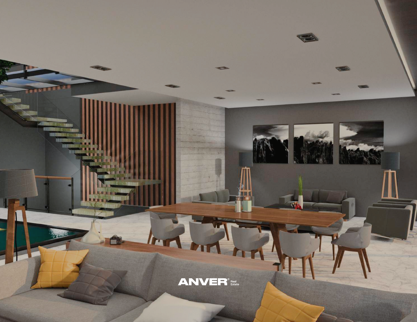 Sala de estar moderna con sofá gris, cojines amarillos y grises, mesa de comedor de madera, sillas blancas, lámparas de madera y tela, paredes grises, tres cuadros de paisaje montañoso en blanco y negro, escaleras flotantes con barandilla de vidrio a la izquierda, suelo de mármol, zona con ventanas y plantas decorativas.