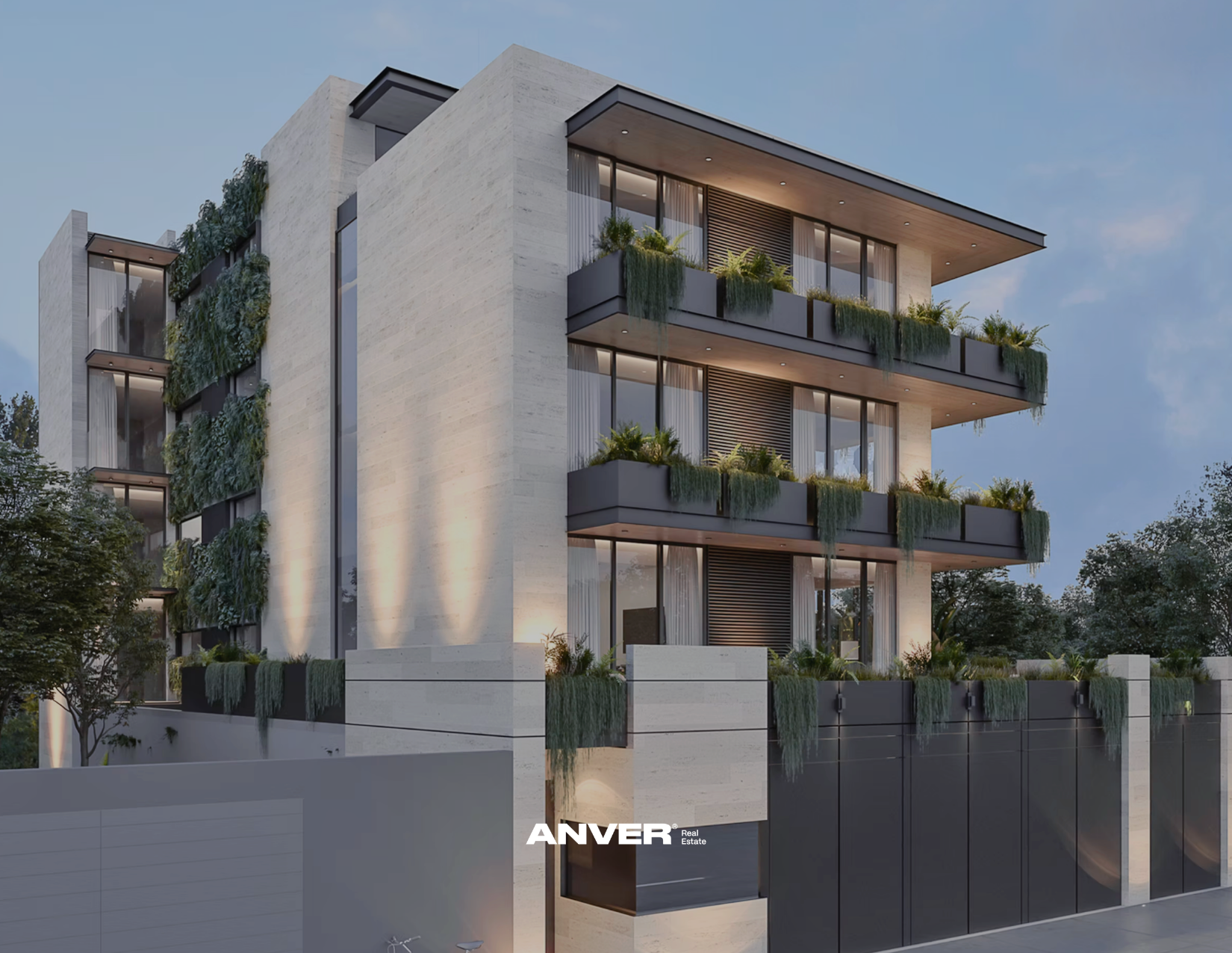 Edificio moderno de varios pisos con balcones de plantas verdes y ventanas grandes, iluminación exterior en la noche, y el logo de ANVER en la parte inferior